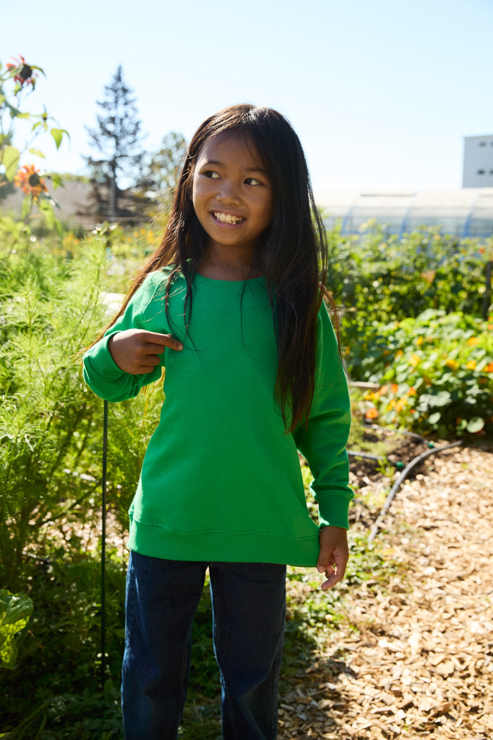 Lifestyle image of children wearing Luxury Organic Fairtrade Cotton Kids Sweatshirt, highlighting the elegant fit and sustainable materials in a casual setting.