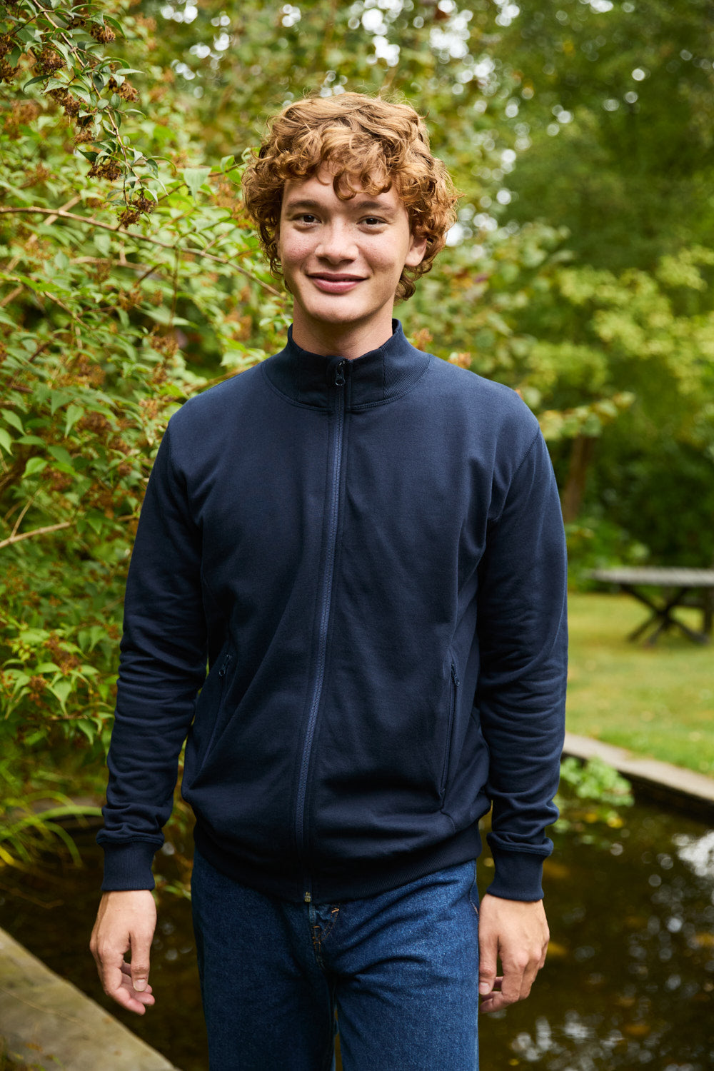 Luxurious Fairtrade organic cotton high neck jacket for unisex wear, featuring soft brushed inner, eco-friendly design, and elegant reversed YKK zipper, showcasing craftsmanship and sustainability.