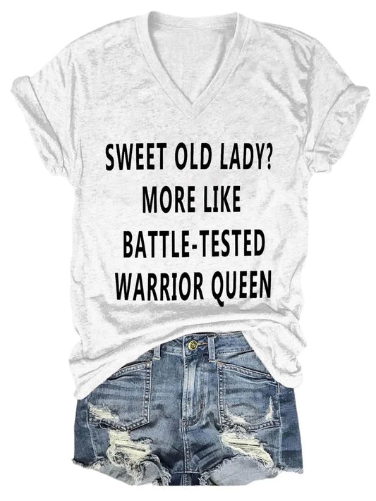 Women's Sweet Old Lady V-Neck T-Shirt in elegant white, adorned with the bold statement 'Sweet Old Lady? More Like Battle-Tested Warrior Queen'. Ideal for expressing strength and sass in luxury fashion.