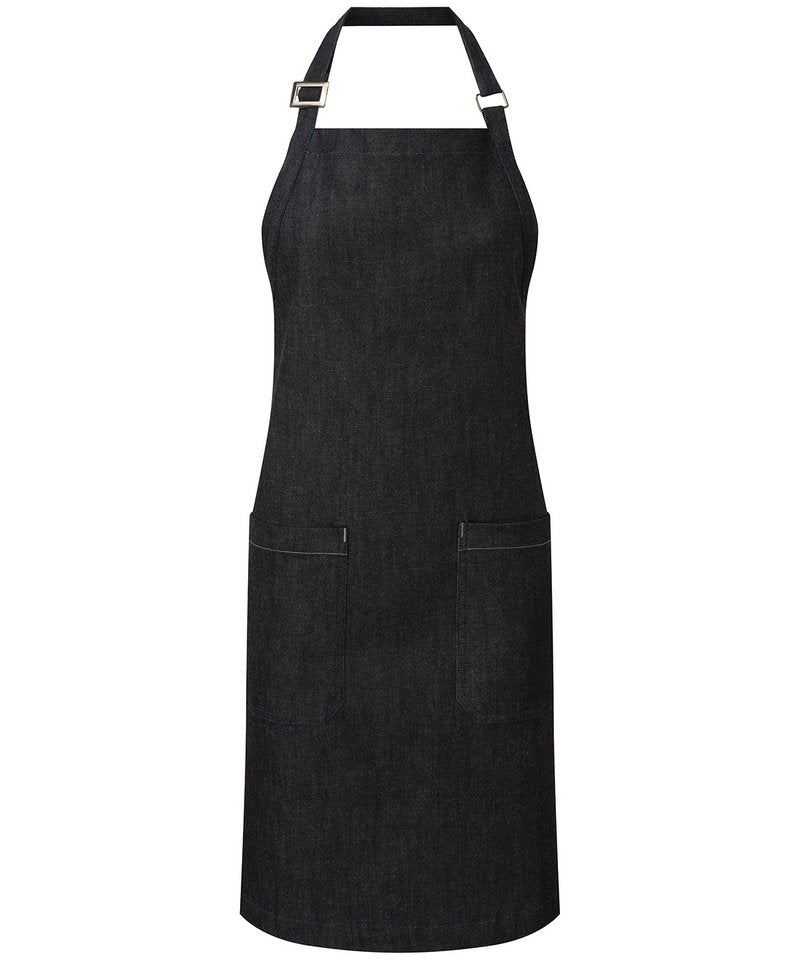 Stylish organic cotton denim bib apron featuring adjustable straps, antique brass hardware, and sustainable craftsmanship ideal for culinary enthusiasts.