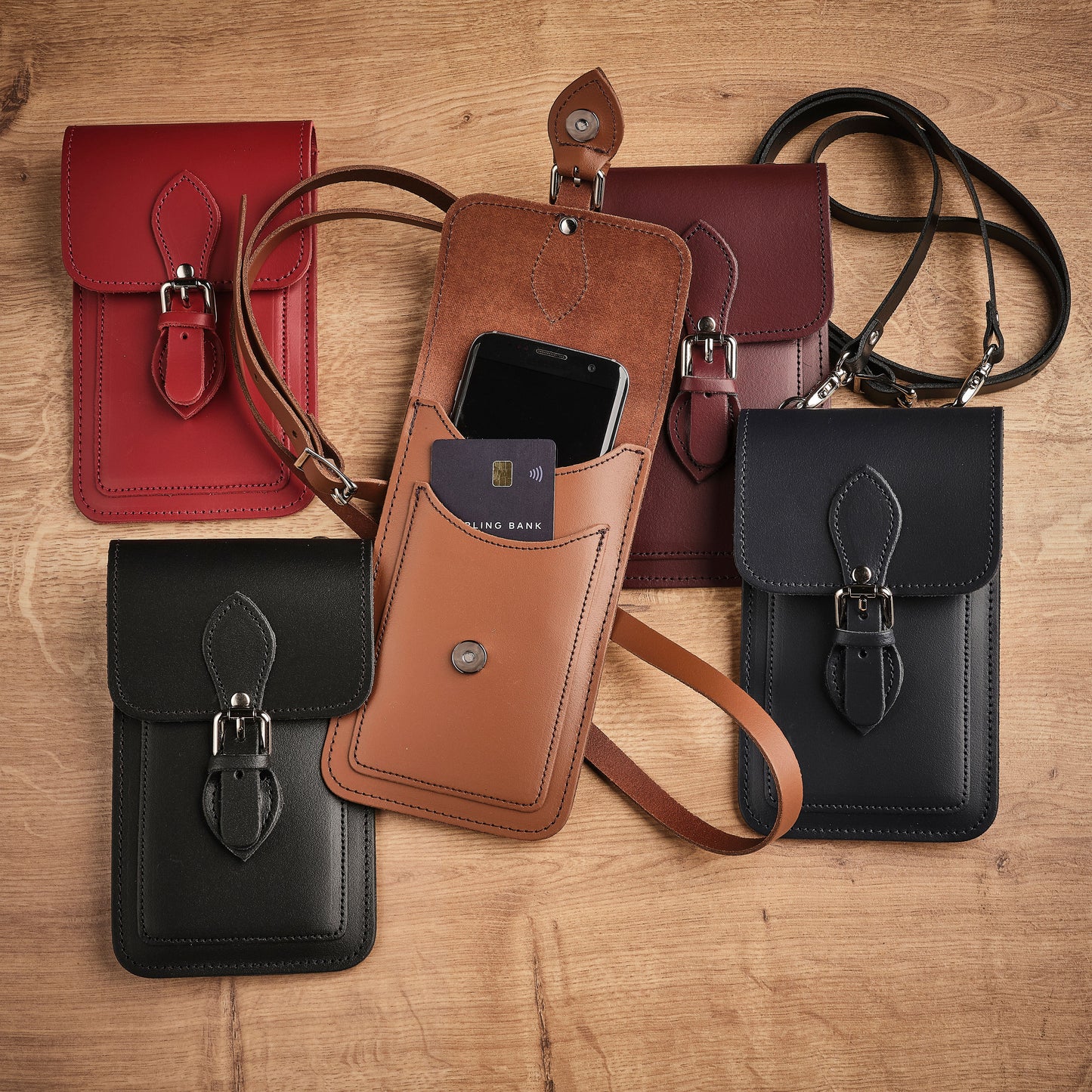 Stylish Zatchels Handmade Chestnut Leather Mobile Phone Pouch in a sophisticated setting, reflecting luxury and personalisation possibilities.