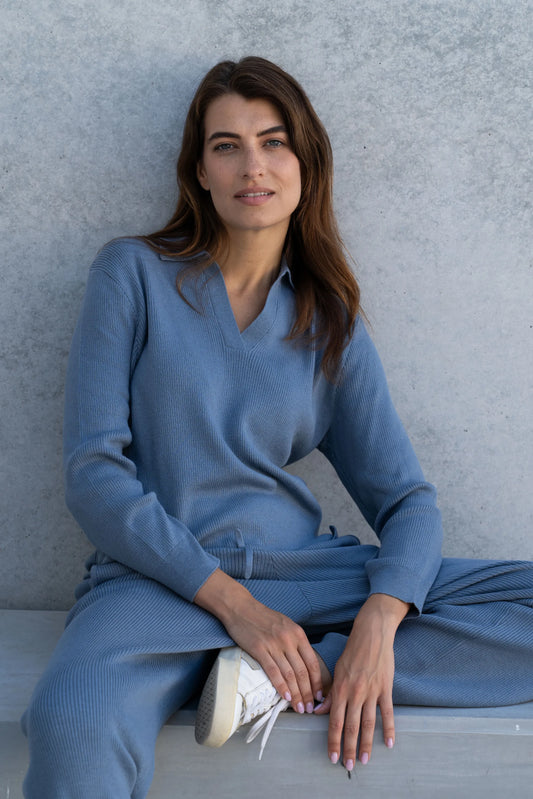 Elegant close-up of ribbed fabric on luxury wide-leg trousers, crafted from a soft blend of 85% Pima cotton and 15% baby alpaca, perfect for sophisticated lounging.