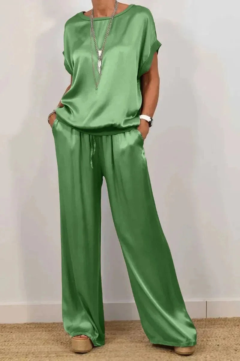 Sophisticated summer fashion ensemble for women, comprising of a relaxed O-neck satin t-shirt and flowing wide leg trousers.