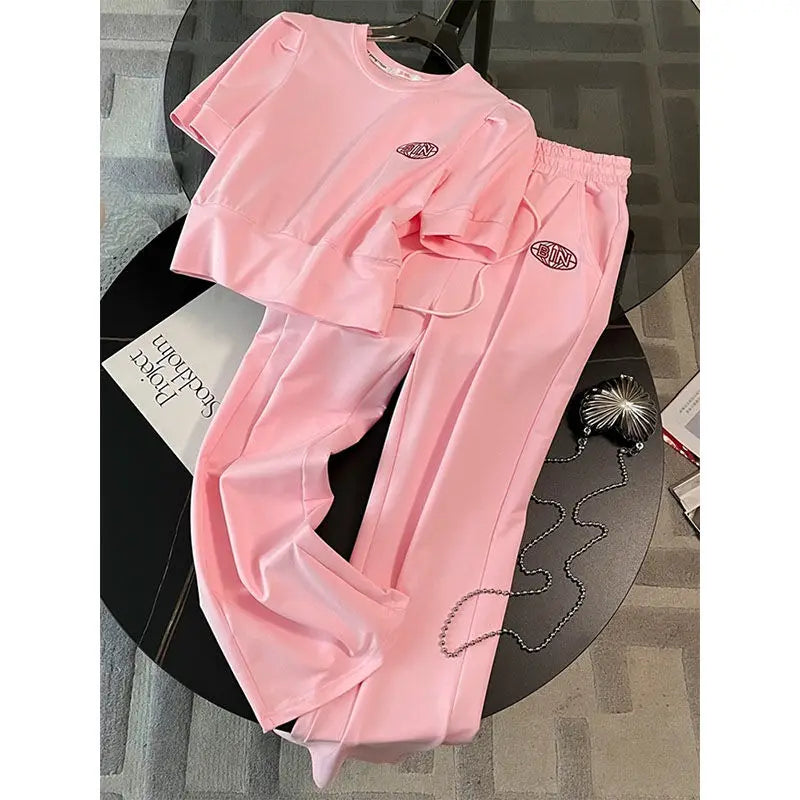 Luxurious leisure summer sports set for women featuring a sweet style short sleeve t-shirt paired with elegant wide leg pants, high stretch fabric in solid colours, perfect for casual yet sophisticated summer outings.