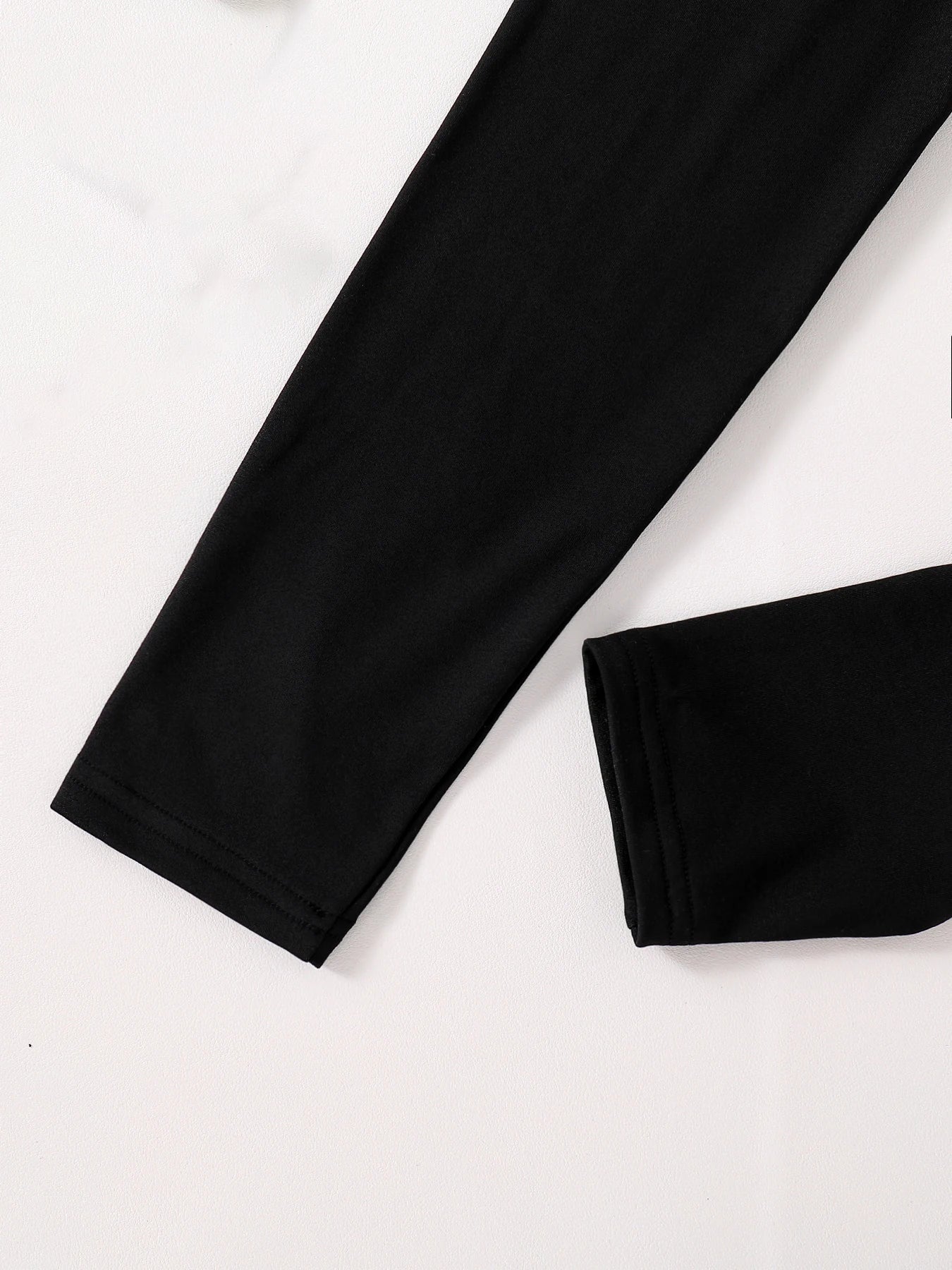 Chic ensemble of the English print round neck top paired with elegant slim fit pants, demonstrating a refined autumn look for discerning young girls.