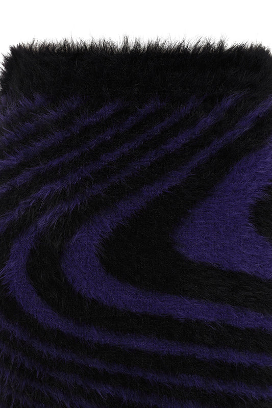 Close-up of the plush black and deep purple swirl pattern of the Daphne Mini Skirt, emphasising its unique gothic aesthetic and comfortable fit.