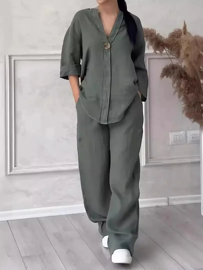 Stylish woman wearing a complete luxury cotton linen two-piece set consisting of a casual V-neck blouse and high elastic wide leg pants.