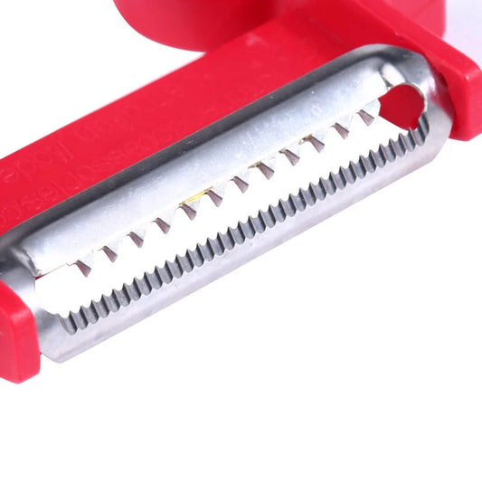 Detailed view of the Magic Trio Peeler featuring the julienne blade in vibrant red, ideal for creating elegant garnishes and vegetable ribbons.