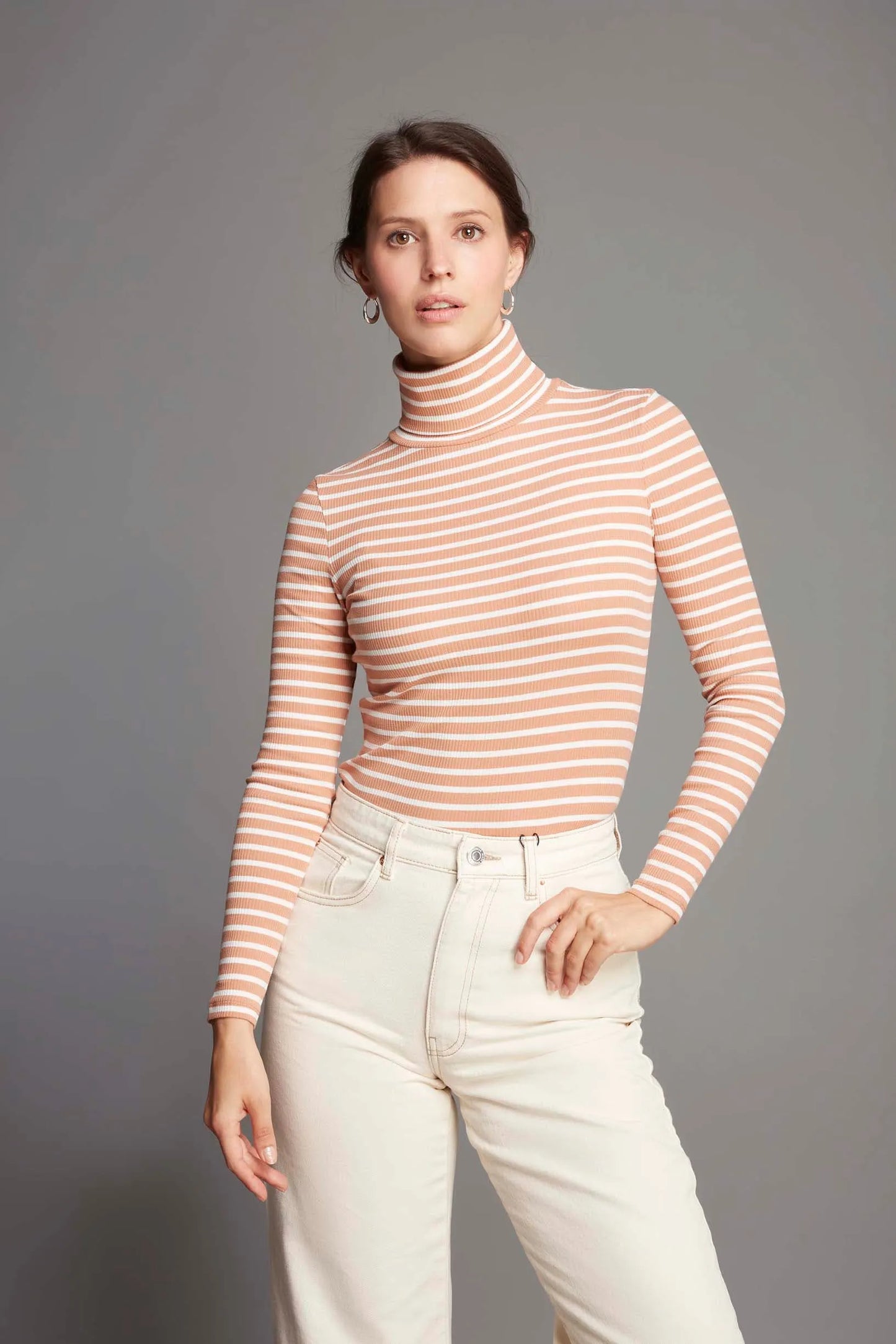 Model wearing Luxury Women's Striped Long Sleeve Cotton Roll Neck Top, showcasing its versatility as an elegant layering piece for various occasions.