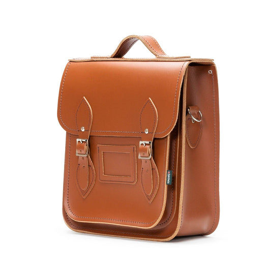 Elegant Handmade Chestnut Leather City Backpack showcasing premium British craftsmanship, featuring chic chestnut exterior, silver nickel buckles, and a spacious interior.