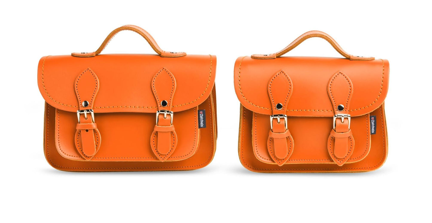 Close-up of Zatchels Handmade Orange Leather Micro Satchel showcasing exquisite nickel silver buckles and vibrant leather finish.