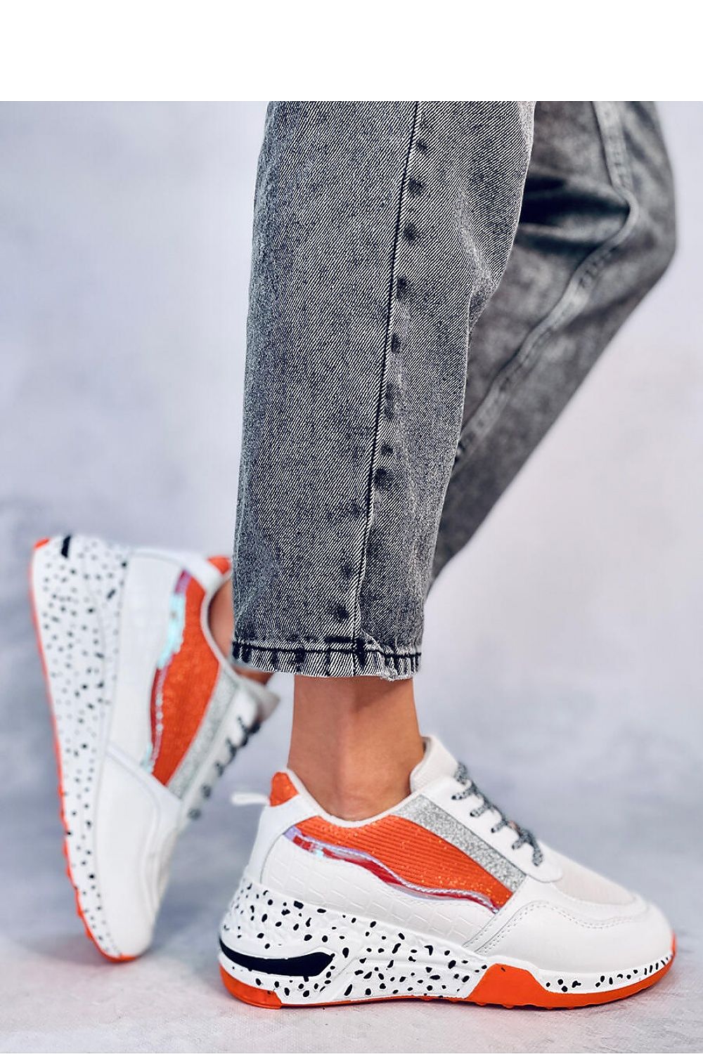 Elegant Inello luxury sports shoes on a high sole, incorporating fashionable snake skin motif and glitter details, ideal for adding a touch of sophistication to any outfit.