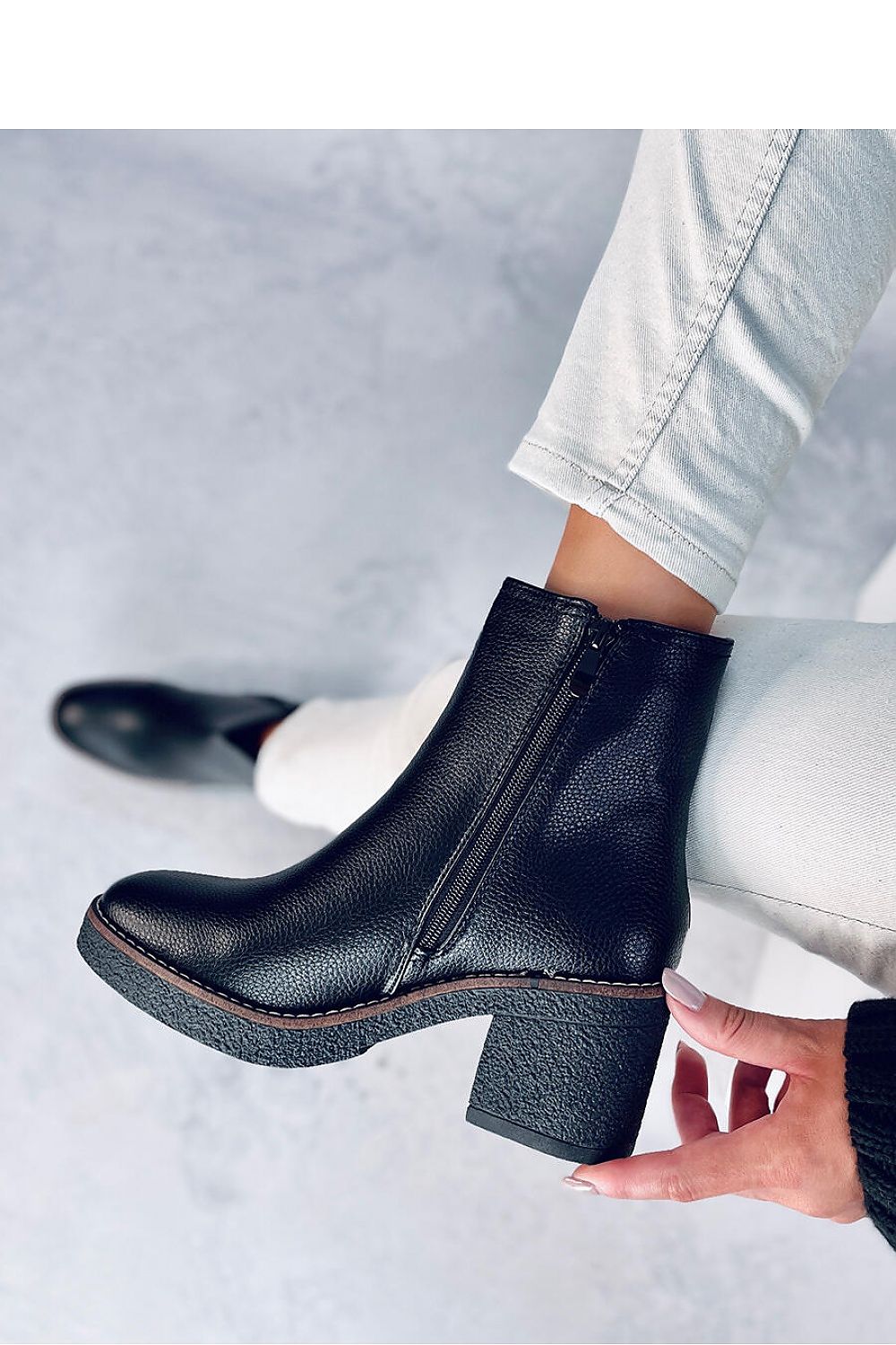 Stylish Inello Women's Classic Heel Boots, offering a 7 cm rubber heel, superior organic leather construction, and a decadent soft fur lining, ideal for an elegant wardrobe.