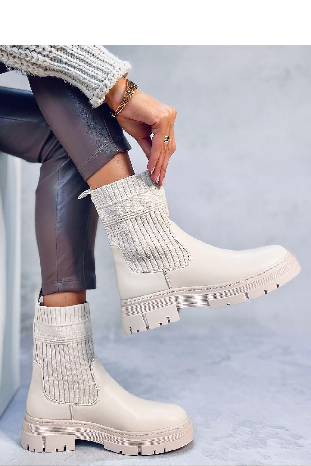 Elegant Women’s Inello Boots designed with a thick sole, elastic fabric upper, eco-leather finish, and cosy soft fur inside, perfect for sophisticated winter wear.