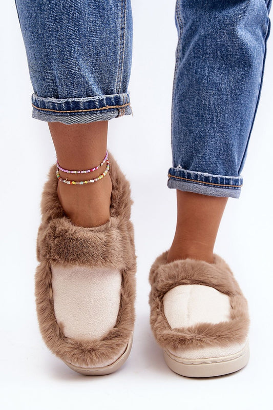 Chic view of luxury eco-suede slippers featuring a plush fur lining and rubber sole, elegantly worn by a model in denim, by Step in Style.