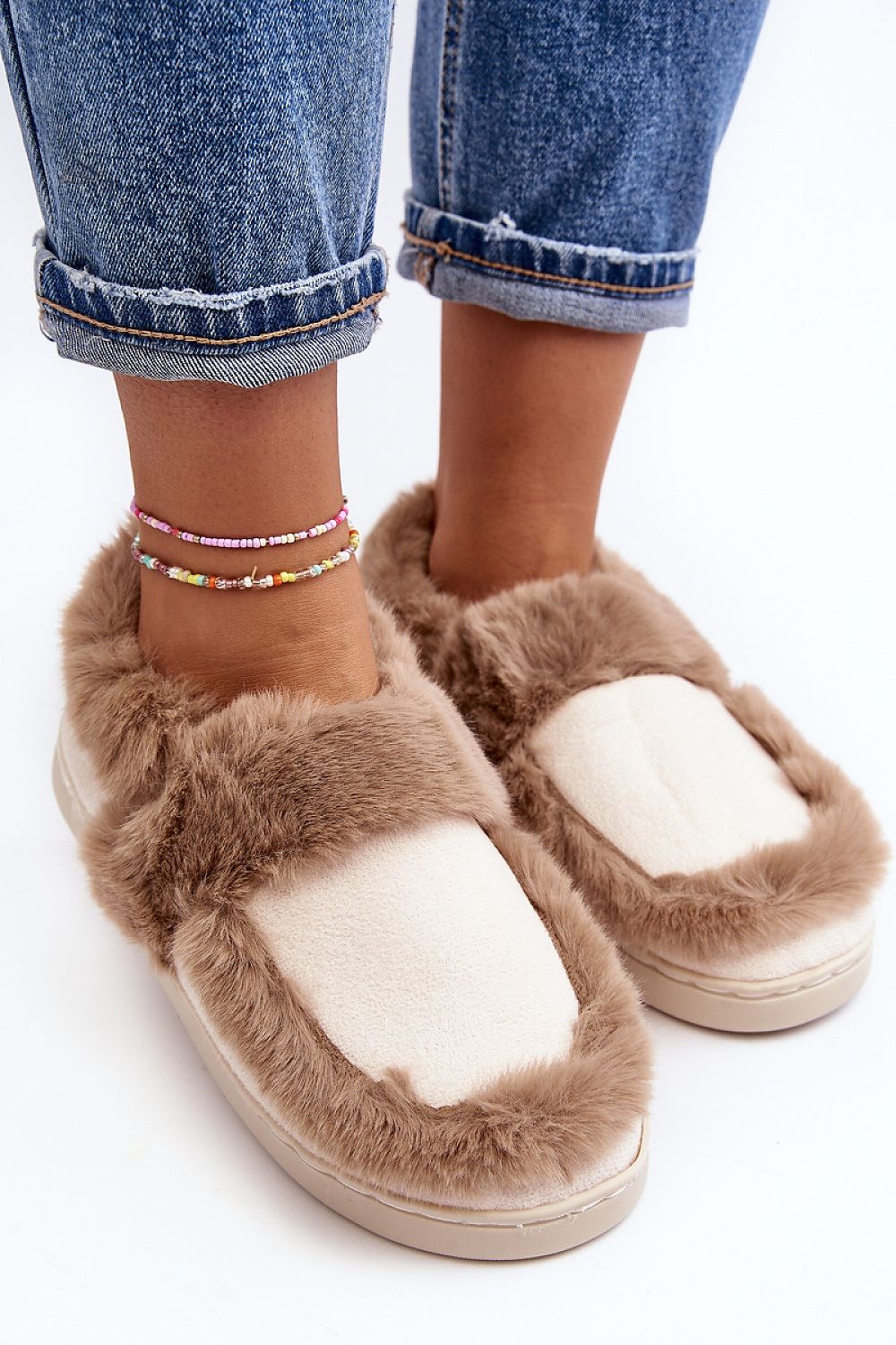 Close-up of luxury eco-suede slippers with soft fur detailing, exuding comfort and style, as modelled with fashionable denim by Step in Style.