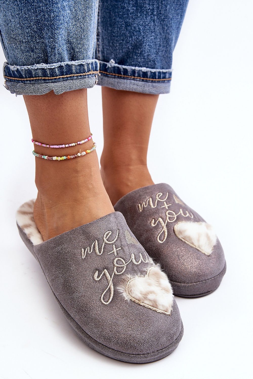 Luxurious and trendy women's slip-on slippers from Step in Style, featuring a soft fur insole and stylish heart embellishment for ultimate comfort.