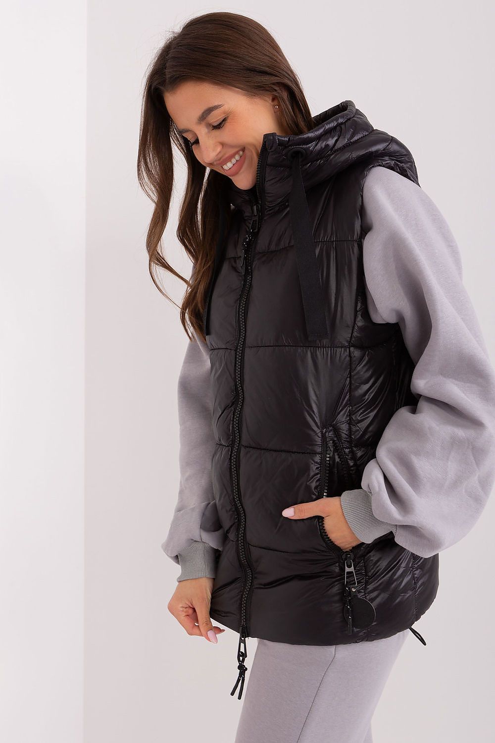 Men's fashionable Sublevel Quilted Insulated Hooded Vest displayed outdoors, exemplifying modern style and comfort in versatile outerwear.