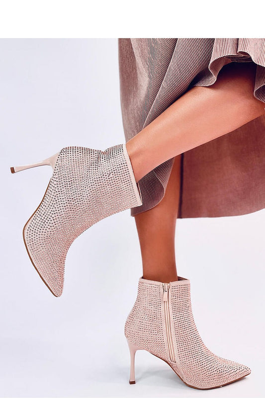 Close-up of luxury women's stiletto heel boots with sparkling crystals, featuring eco-suede by Inello, perfect for high-fashion looks.