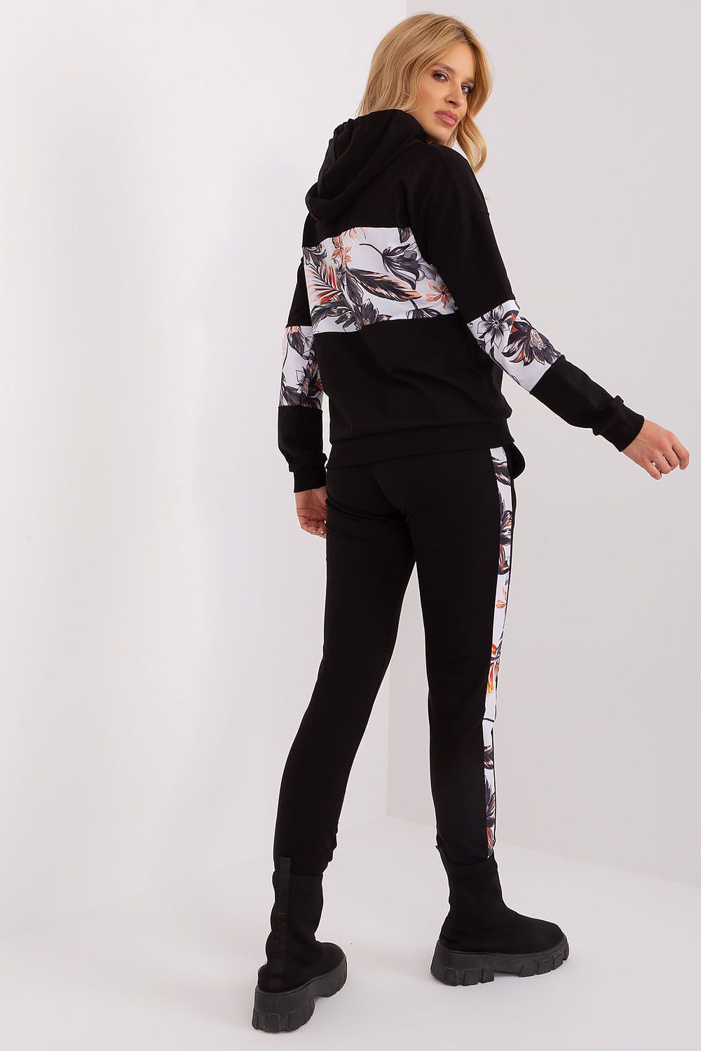Casual yet stylish women’s tracksuit set by Relevance, featuring a comfortable hoodie with floral inserts and high-rise pants, ideal for modern elegance.