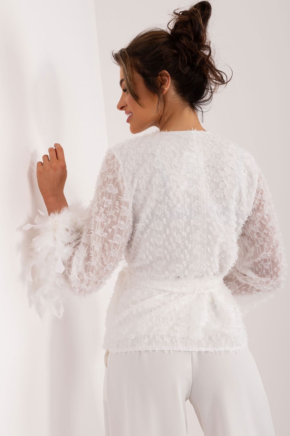 Close-up of the decorative feathered cuffs on the chic cotton blend blouse by Lakerta, emphasizing its luxurious and feminine appeal.