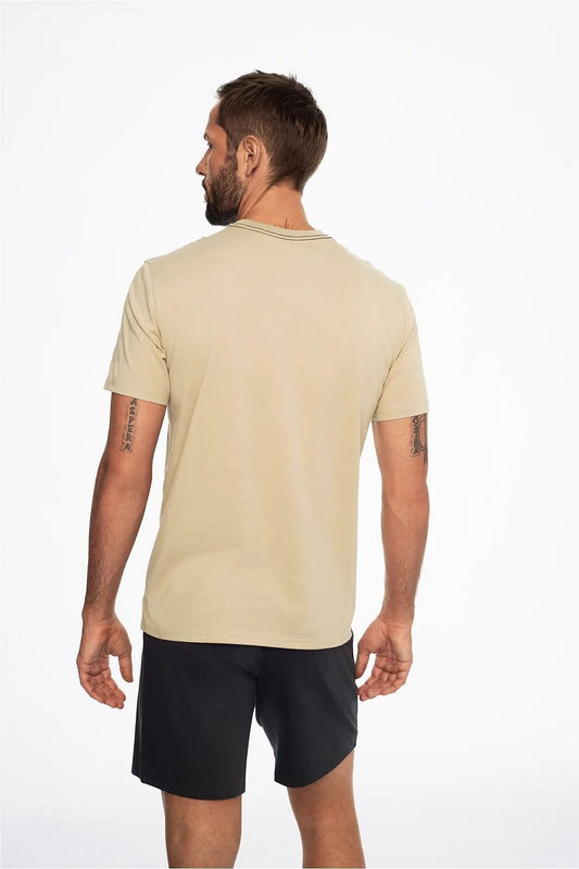View of the back of Henderson's cotton pajama set, showcasing a sleek beige T-shirt and comfortable black shorts, perfect for stylish relaxation.