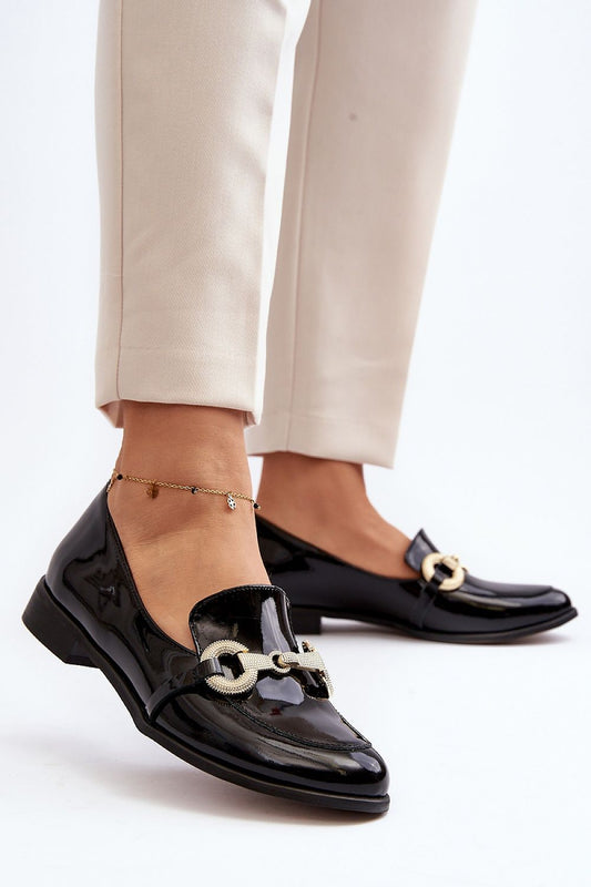 Chic black moccasins from Step in Style, adorned with sophisticated gold detailing, ideal for a refined look in spring and autumn.