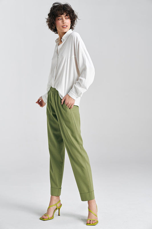 Chic Nife ecru oversized viscose shirt paired with trendy green trousers, showcased by a model in a neutral backdrop, perfect for a sophisticated summer look.