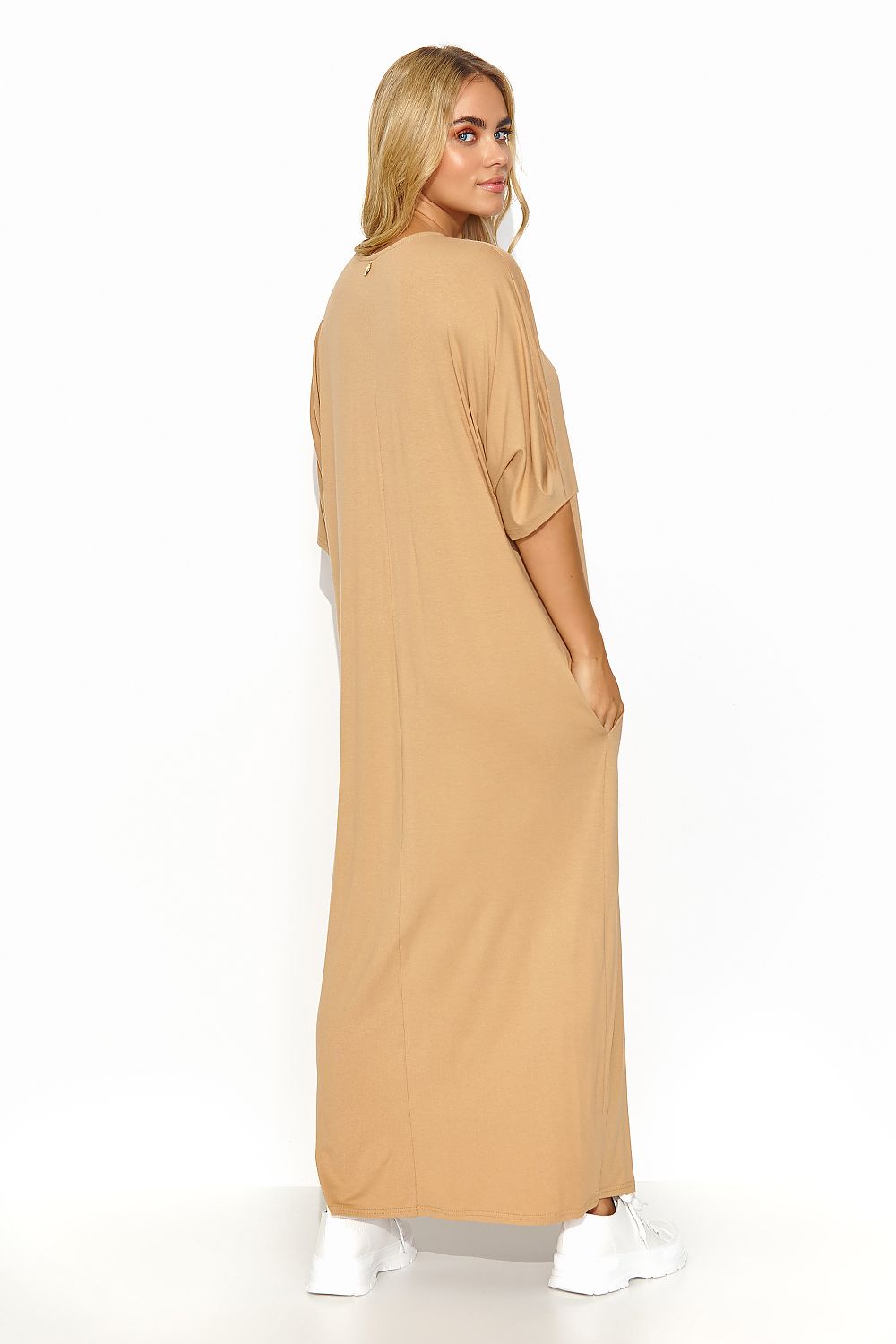 Back view of a fashionable beige Makadamia long dress, highlighting a luxurious soft fabric and a relaxed silhouette, perfect for warm weather.