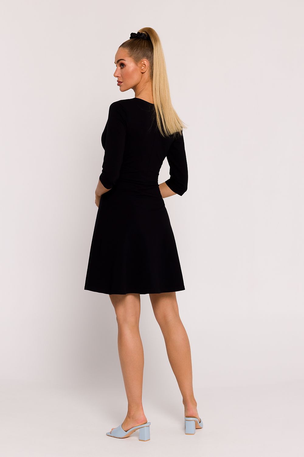 Model wearing Moe Elegant Mini Knit Dress, radiating sophistication with elbow-length sleeves and seamless blend of style and comfort.