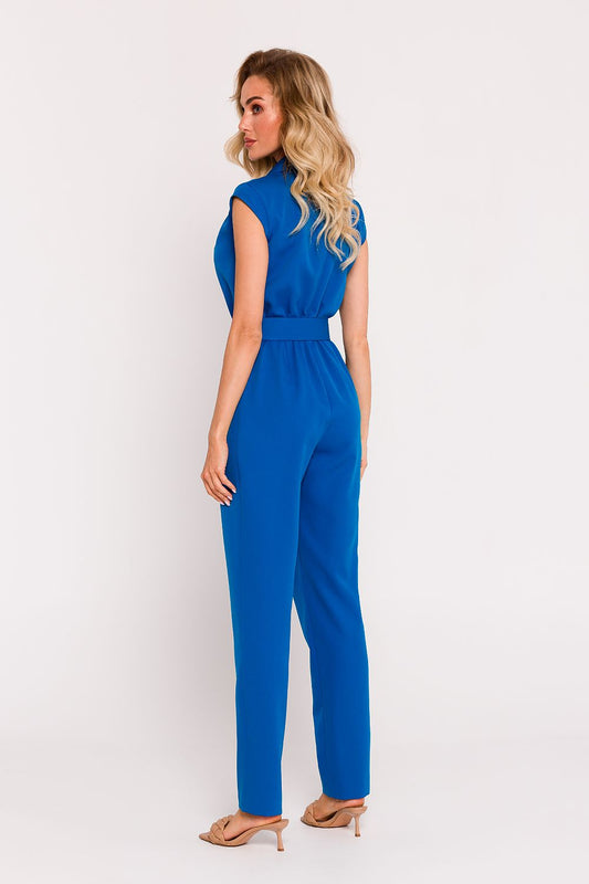 Elegant Polish tailored jumpsuit by Moe featuring a sophisticated asymmetrical design and a stylish belted waist.