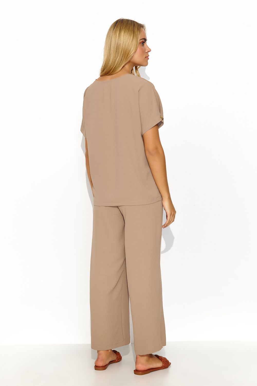 Fashionable display of Makadamia's Elegant Women's 2-Piece Set, highlighting the luxurious fabric and stylish design of V-neck blouse and wide-leg trousers.