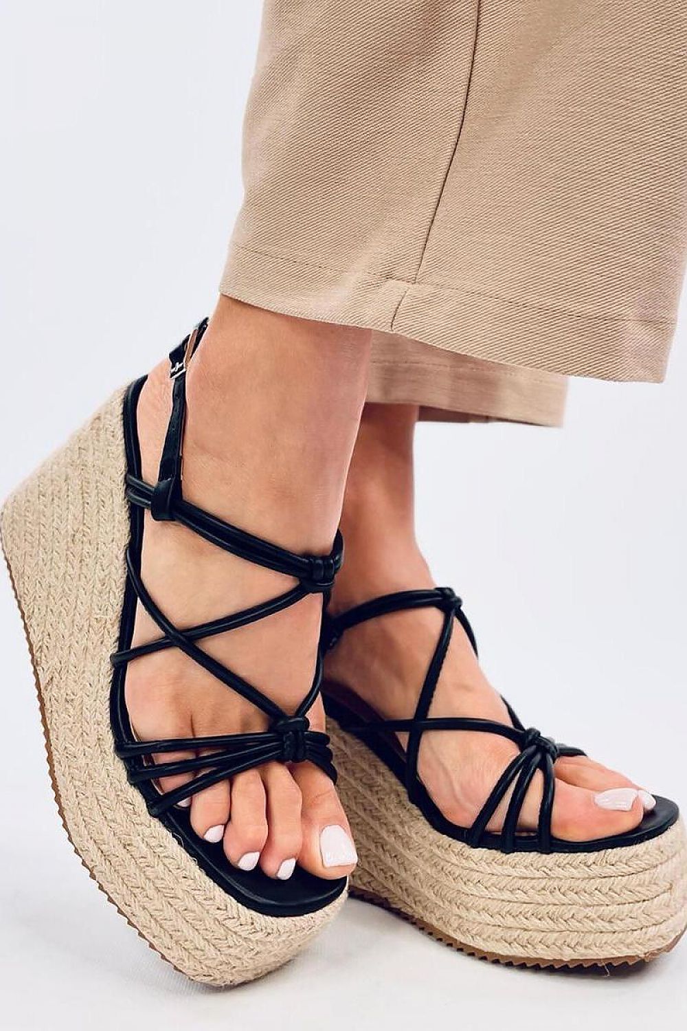 Sophisticated angled view of Inello women’s black espadrilles sandals on an 11cm heel, emphasizing the chic cross straps and eco-friendly construction, ideal for a luxurious fashion statement.