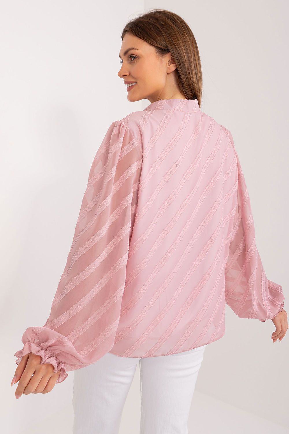Back view of an elegant women's long sleeve button-down shirt by Lakerta in pastel pink, showcasing the sophisticated design and textured fabric, ideal for adding a touch of luxury to any outfit.