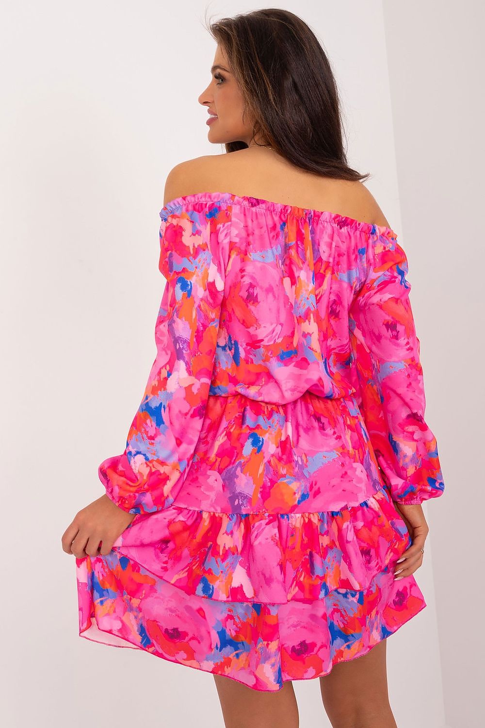 Stylish back view of the Rue Paris summer mini dress, adorned with a colourful floral design, flared hem, and off-the-shoulder sleeves, perfect for a chic summer outing.