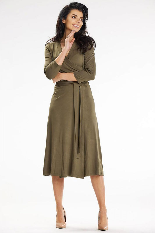 Elegant olive midi dress by Awama featuring a fitted top, 3/4 sleeves, and a stylish waist belt, ideal for sophisticated occasions.