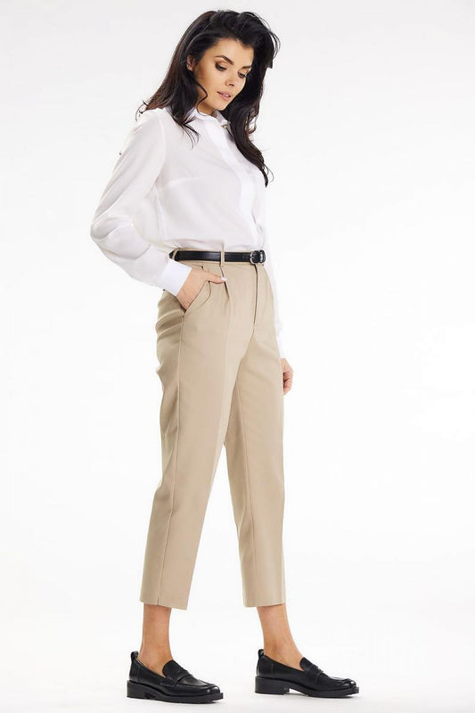 Fashionable profile view of a woman in an elegant Awama long sleeve shirt and chic beige trousers, showcasing a modern and professional style suited for business meetings.