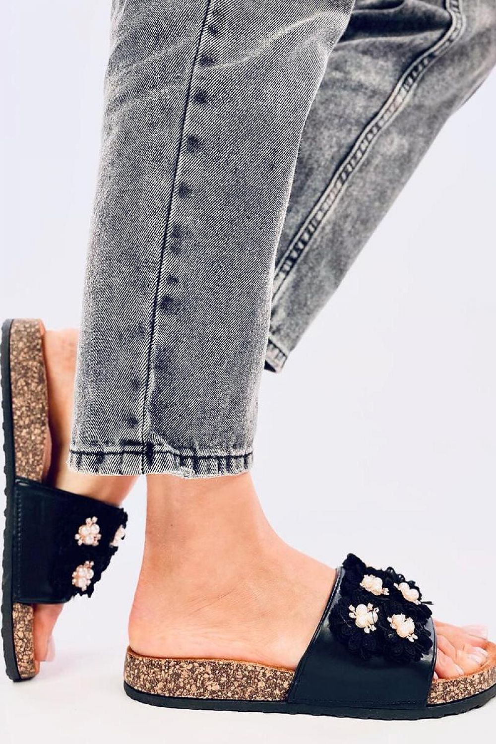 Stylishly presented Inello women's leather sandals with a contoured cork sole, adorned with delicate flowers and rhinestones for a sophisticated summer look.