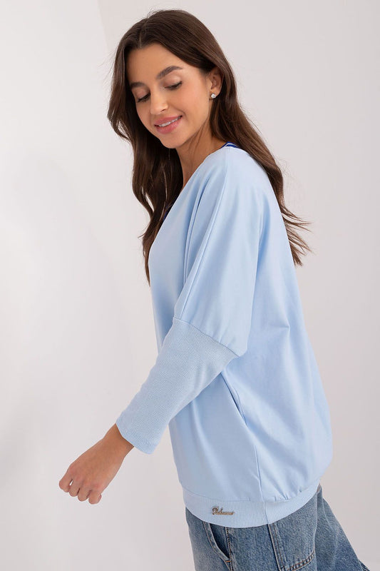 Luxurious cotton blouse by Relevance with 3/4 sleeves and a captivating v-neckline, showcasing an exclusive print ideal for stylish casual outfits.