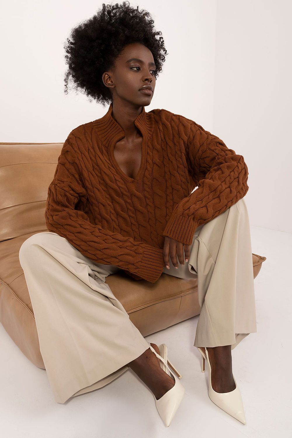 A woman wearing Badu's chic V-Neck Jumper, highlighting the comfort and warmth of the acrylic-wool blend.
