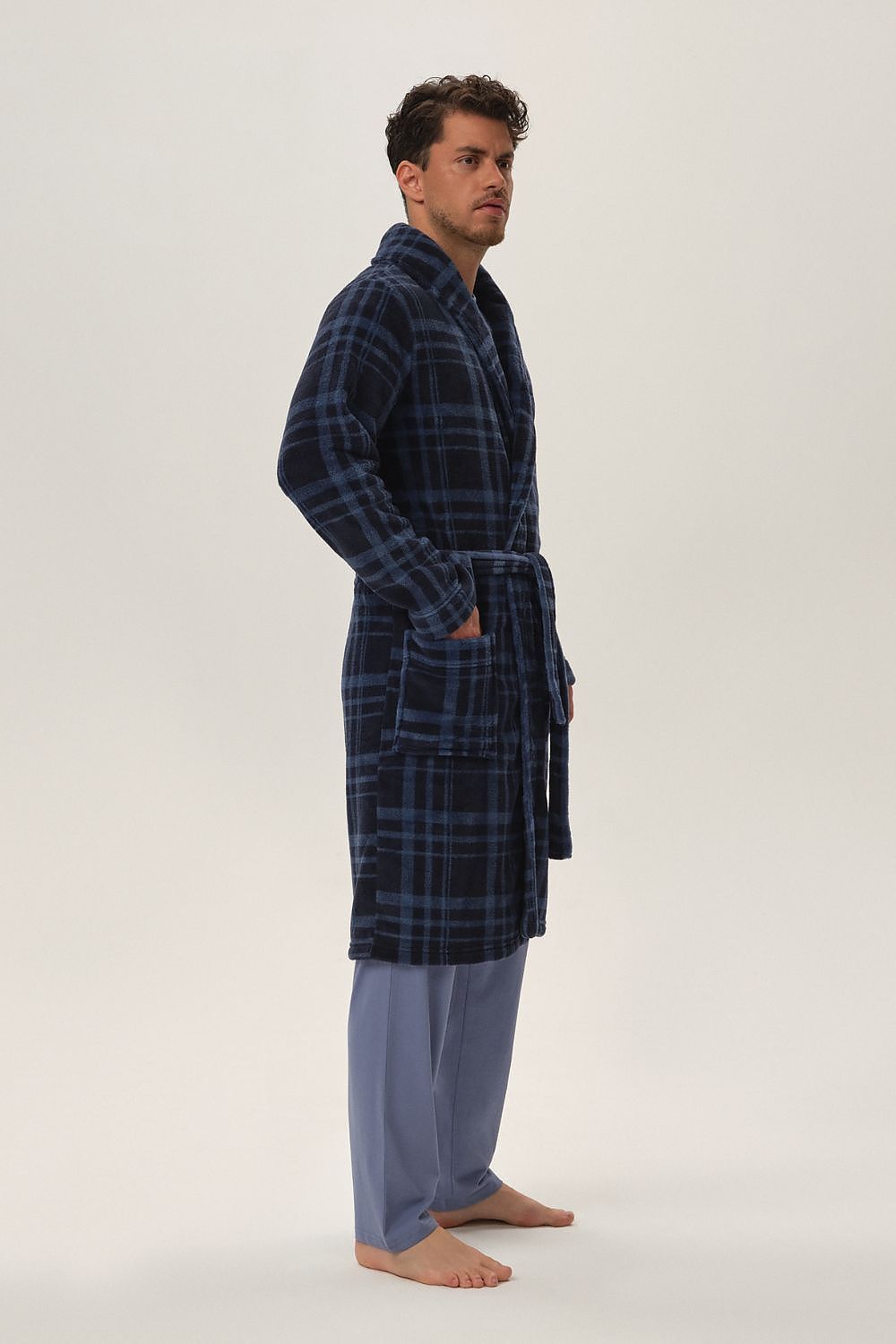 Close-up view of Henderson luxury navy blue men's bathrobe fabric, highlighting the soft polyester material and elegant checkered pattern.
