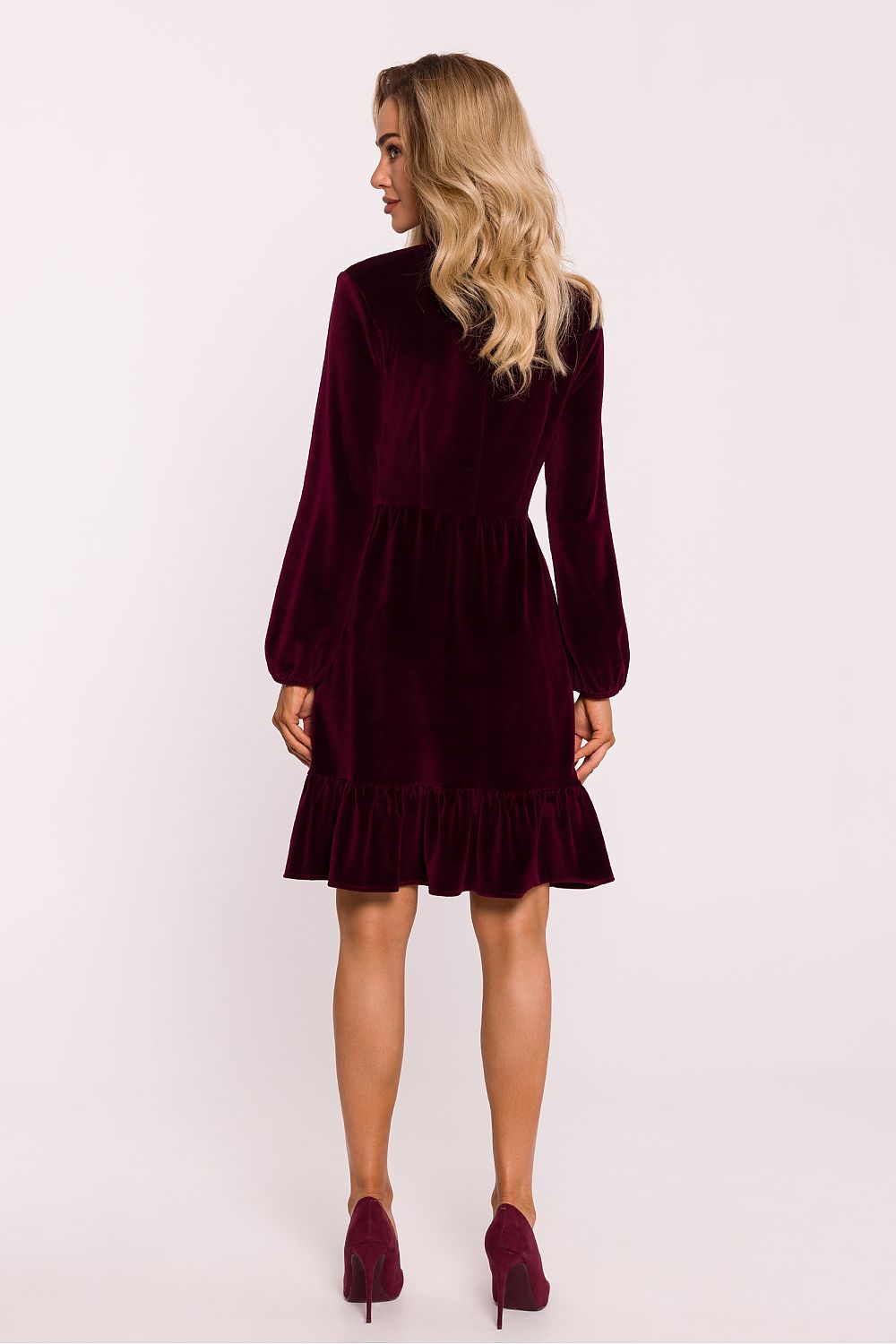 Luxurious velour knit dress by Moe showcasing an emphasized waist and romantic buffet sleeves for a sophisticated look.