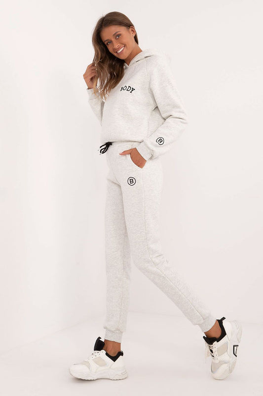 Elegant women's cotton-polyester melange lounge set, showcasing a comfortable sweatshirt with hood and high-waisted pants, designed for warmth and sophistication by Factory Price.