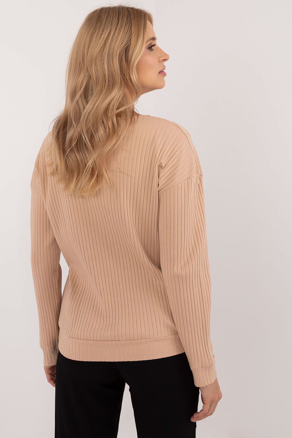 Luxurious long-sleeve blouse from Relevance, showcasing a fashionable v-neck and unique animal motif pocket, ideal addition to modern wardrobes.