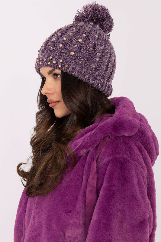 Elegant AT branded women's winter beanie cap in soft material, featuring delicate zircon accents and a fashionable fluffy pom-pom.