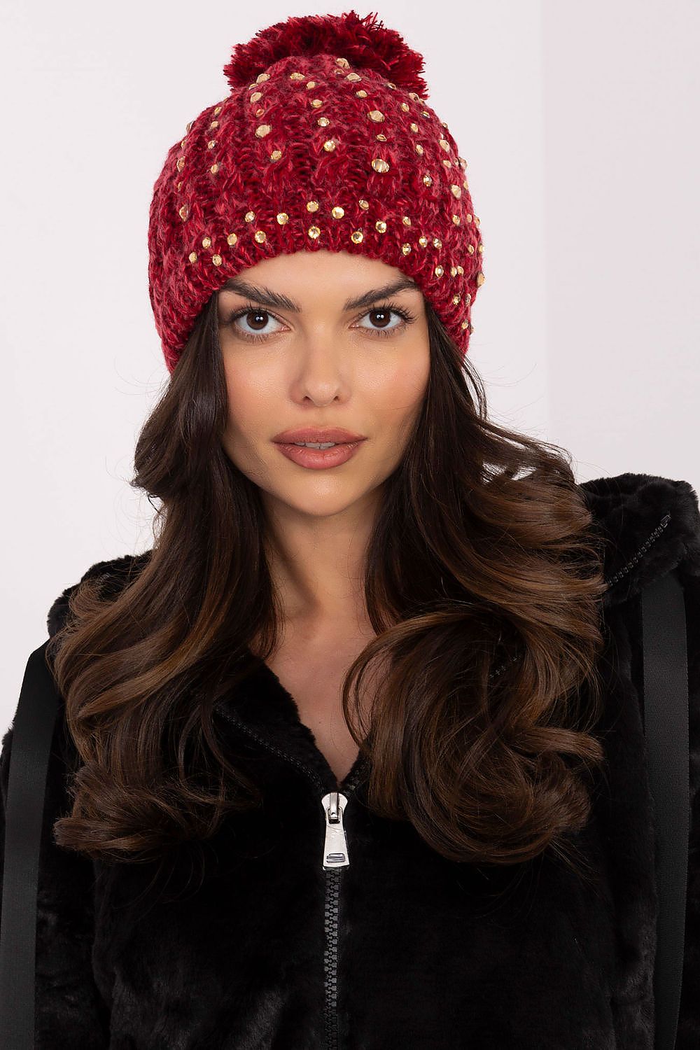 Sleek acrylic women's beanie cap by AT with a fashionable fluffy pom-pom and shimmering zircon accents for a luxurious winter look.