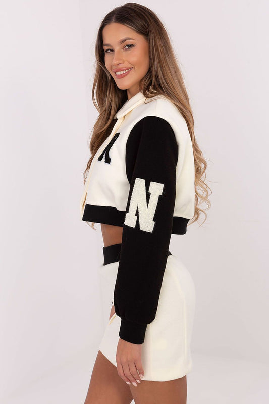 Close-up of the embroidered details on the women's polyester blouse from NM, showcasing luxurious craftsmanship in a fashionable casual set.