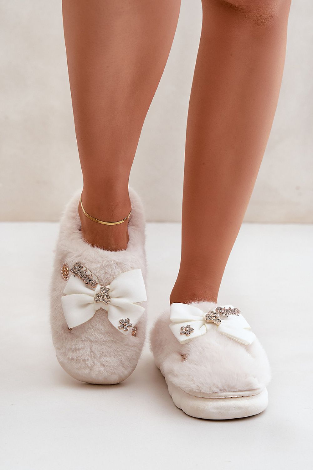 Elegant and cozy Luxurious Furry Slippers by Step in Style, designed for ultimate comfort with charming bow and button details.