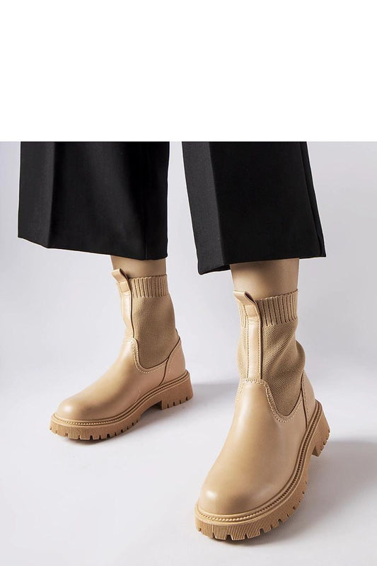 Chic beige eco-suede ankle boots from Solea showcased on a decorative background, embodying luxury and versatility for any wardrobe.