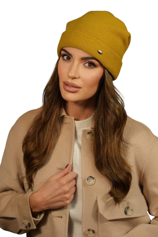 Close-up view of Kamea Women's Wool Beanie showcasing its delicate cuff and metal plate detail, designed for a perfect fit and refined winter style.